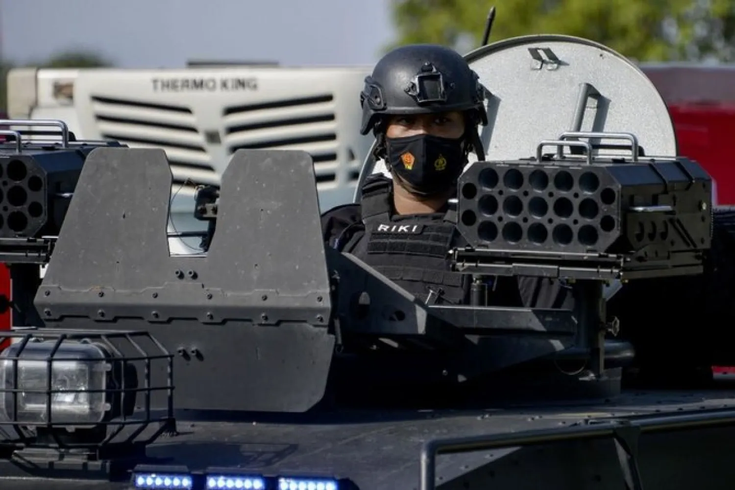 Indonesian police provide security for refridgerated trucks transporting vaccines for the Covid-19 coronavirus, to be distributed to health workers across Aceh province, in Banda Aceh on Feb. 1, 2021. (File/AFP)
