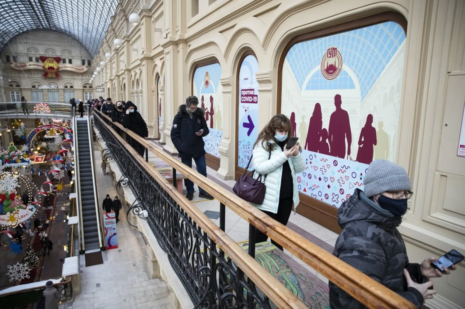 People stand in a queue to get a shot of Russia's Sputnik V coronavirus vaccine in a vaccination center in GUM State Department store in Moscow, Russia, Wednesday, Jan. 20, 2021. (AP)