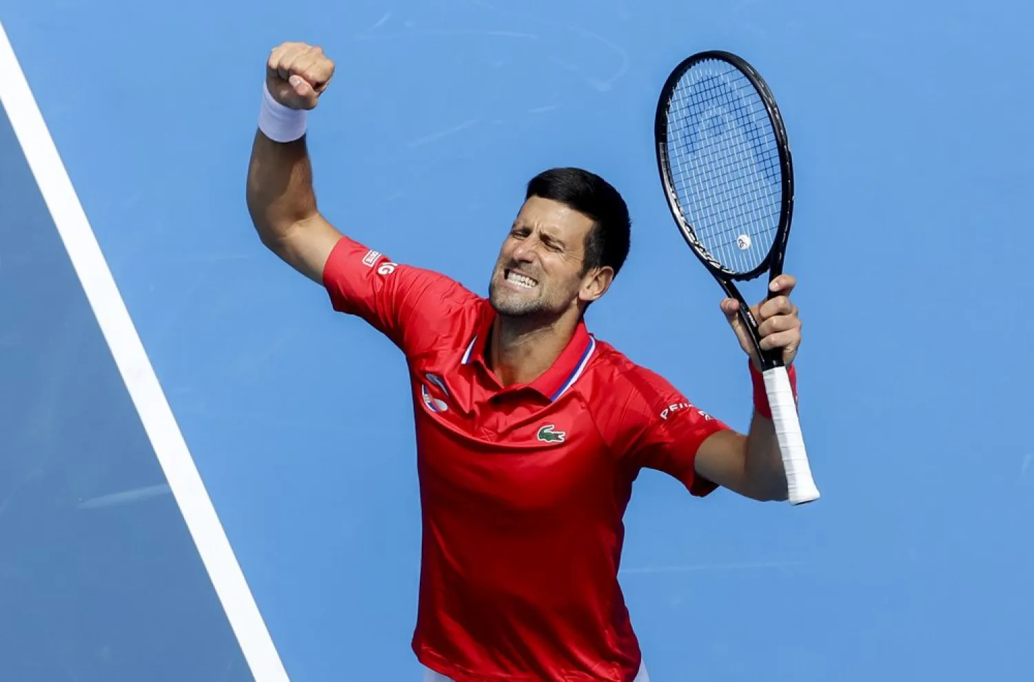 Serbia's Novak Djokovic celebrates after defeating Canada's Denis Shapovalov in their ATP Cup match in Melbourne, Australia, Tuesday, Feb. 2, 2021. (AP)