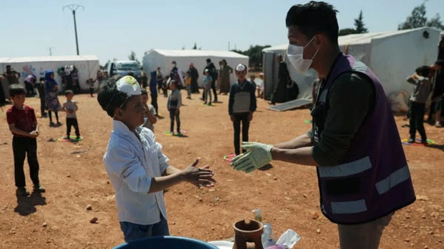A displaced boy takes part in event organzied by Violet Organization, in an effort to spread awareness and encourage safety amid coronavirus disease (COVID-19) fears, at a camp in the town of Maarat Masrin in northern Idlib, Syria April 14, 2020. Picture taken April 14, 2020. (Reuters)
