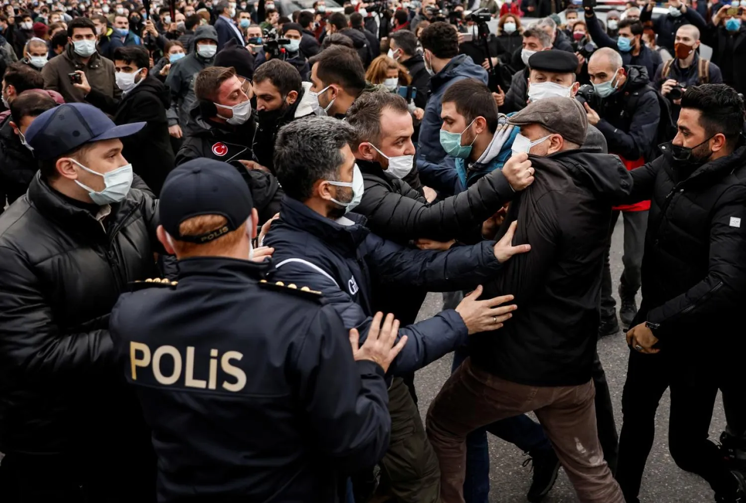 A plainclothes police officer grabs Ahmet Sik, independent member of Turkish Parliament, by the jacket during a gathering in solidarity with Bogazici University students who are protesting against the appointment of Melih Bulu as new rector of the university, in Istanbul, Turkey, February 2, 2021. REUTERS/Umit Bektas