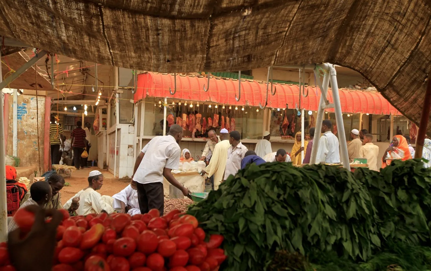 Men wait to buy food at Khartoum's central food market. (Reuters file photo)