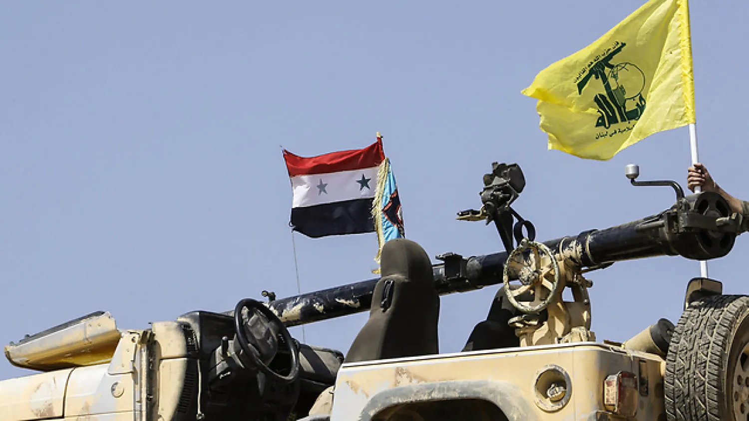 Hezbollah and Syrian flag on a tank in Syria (File Photo: AFP)
