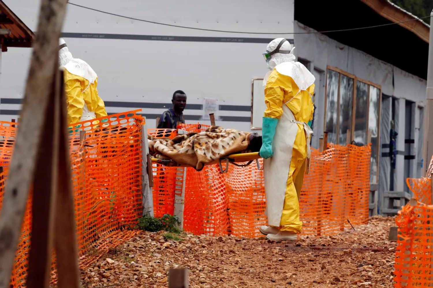 FILE PHOTO: Health workers carry a newly admitted confirmed Ebola patient into a treatment center in Butembo in the eastern Democratic Republic of Congo, March 28, 2019. REUTERS/Baz Ratner