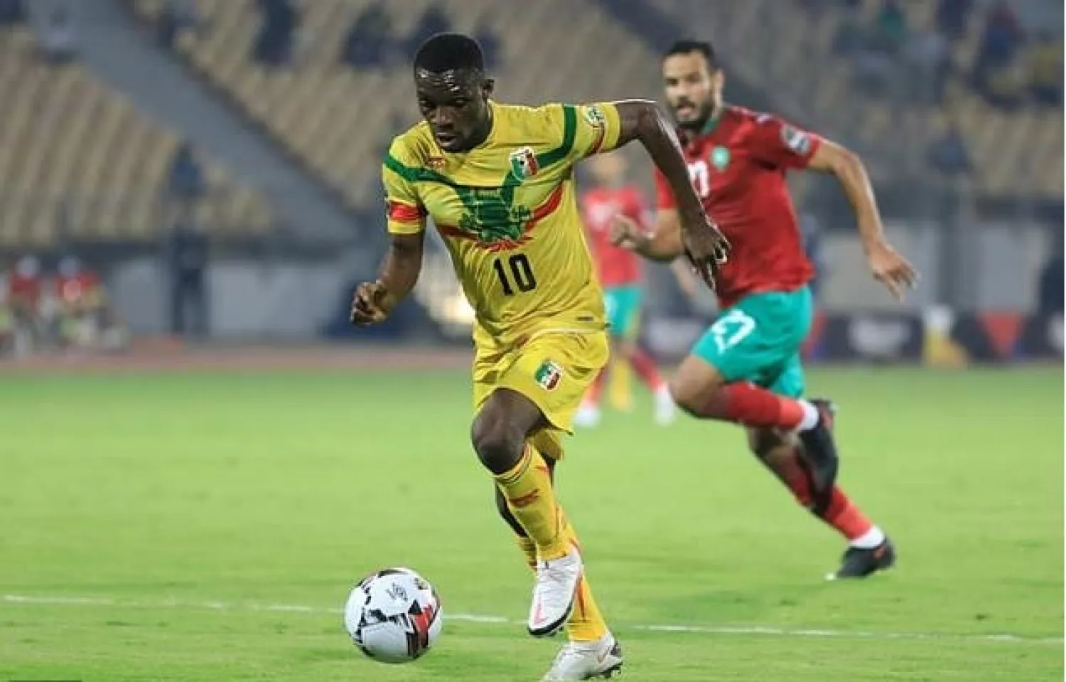 Moussa Kone (L) of Mali is pursued by Abdelmounaim Boutouil of Morocco during the African Nations Championship final in Yaounde Sunday. AFP

