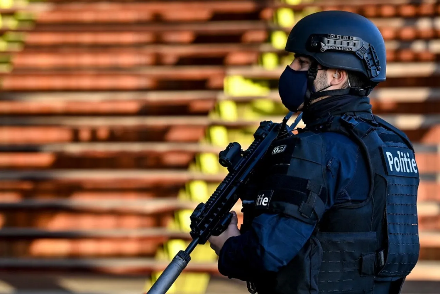 A heavily armed policeman stands outside the courthouse in Antwerp. (AFP)