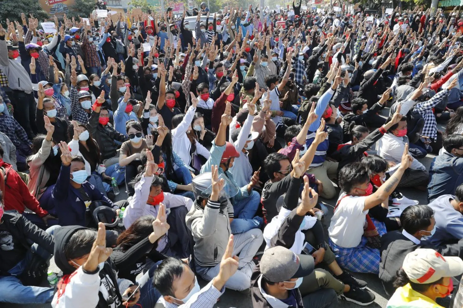 Protesters flash the three-fingered salute, a symbol of resistance, during a protest in Mandalay, Myanmar, Tuesday, Feb. 9, 2021. (AP)