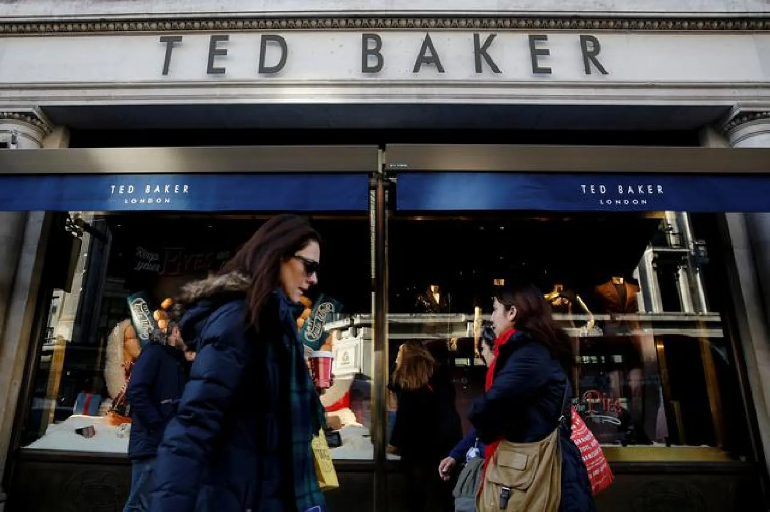 FILE PHOTO: Shoppers walk past a Ted Baker store on Regents Street in London, Britain December 17, 2018. REUTERS/Simon Dawson