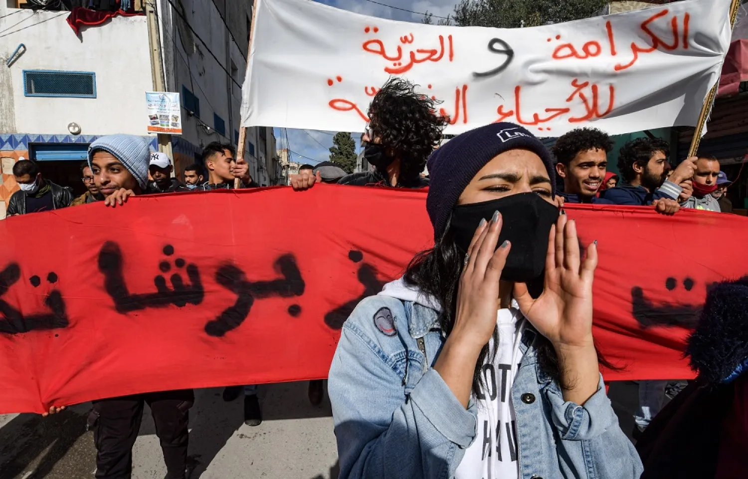 Tunisian police block protesters from accessing the parliament building, in Tunis, Jan. 26, 2021. (AFP)