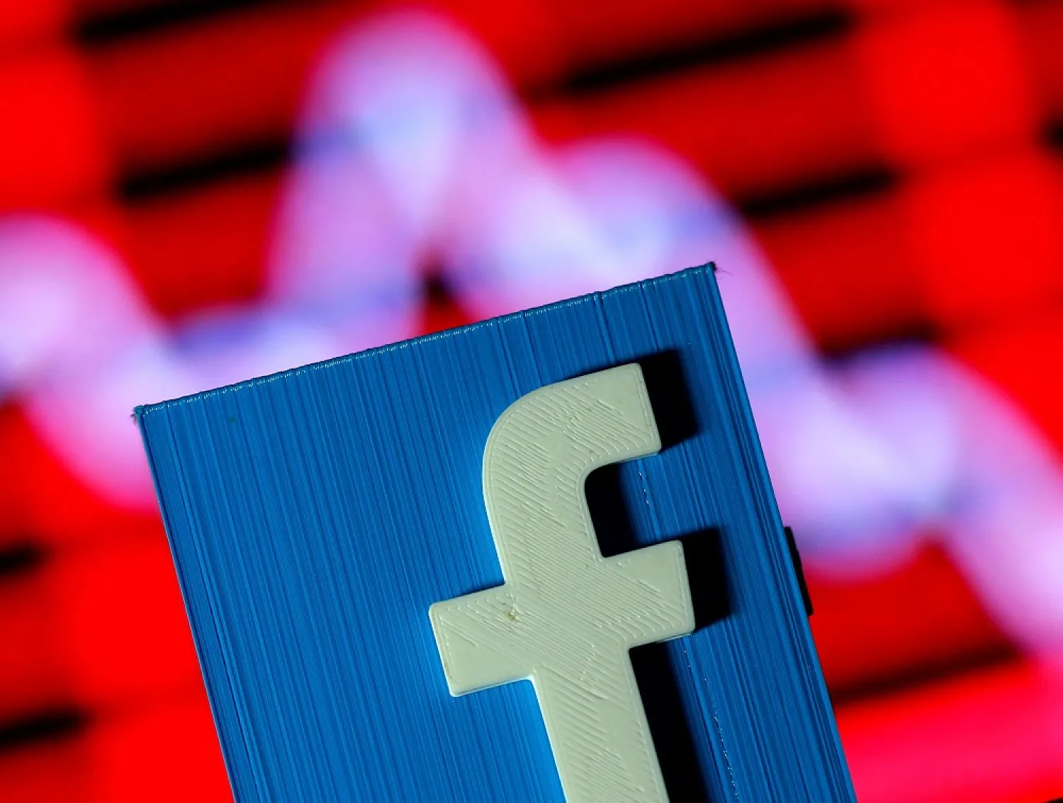 A 3D-printed Facebook logo is seen in front of a stock chart in this illustration taken November 3, 2016. (Reuters)