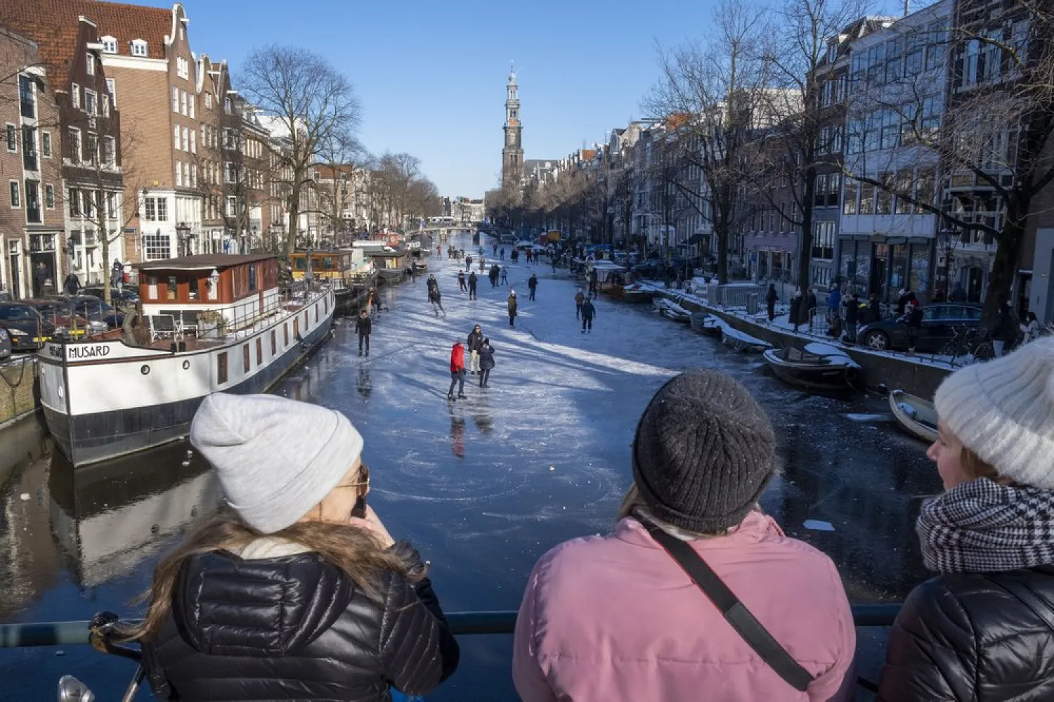 Dozens of skaters took to the frozen surface of Amsterdam's historic Prinsengracht canal in Amsterdam, Netherlands, Saturday, Feb. 13, 2021. (AP)