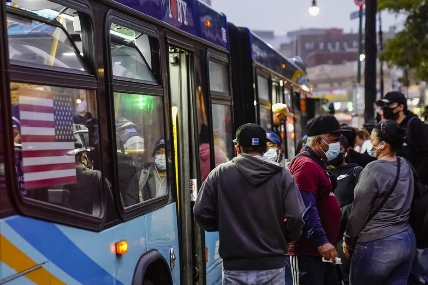 This photo from Thursday, Oct. 22, 2020, show riders exit and enter a bus at the Fordham Metro-North in New York. (AP)