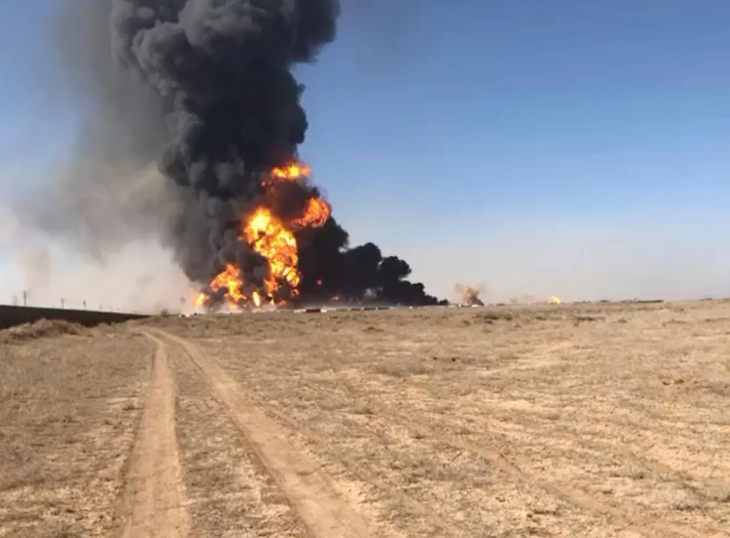In this still image taken from video, smoke rises from fuel tankers at the Islam Qala border with Iran, in Herat Province, west of Kabul, Afghanistan, Saturday, Feb. 13, 2021. (AP Photo)