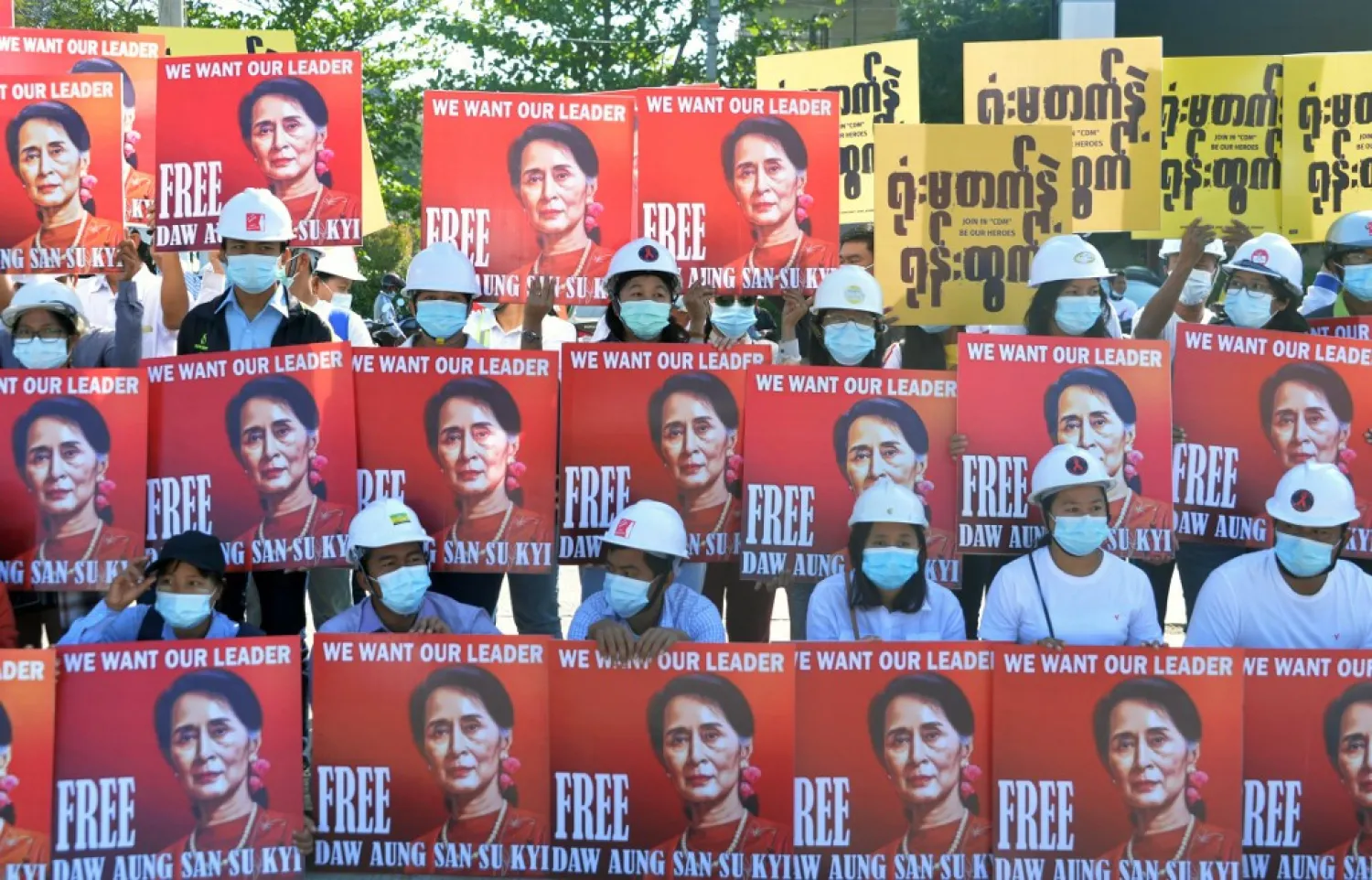 Protesting engineers held up signs calling for the release of Aung San Suu Kyi | AFP