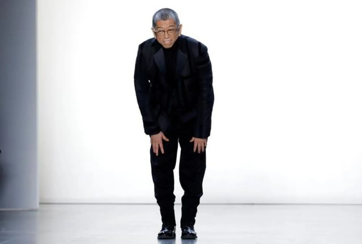 FILE PHOTO: Designer Tadashi Shoji appears on the runway after the showing of his collection during New York Fashion Week in New York City, US, February 7, 2019. REUTERS/Mike Segar
