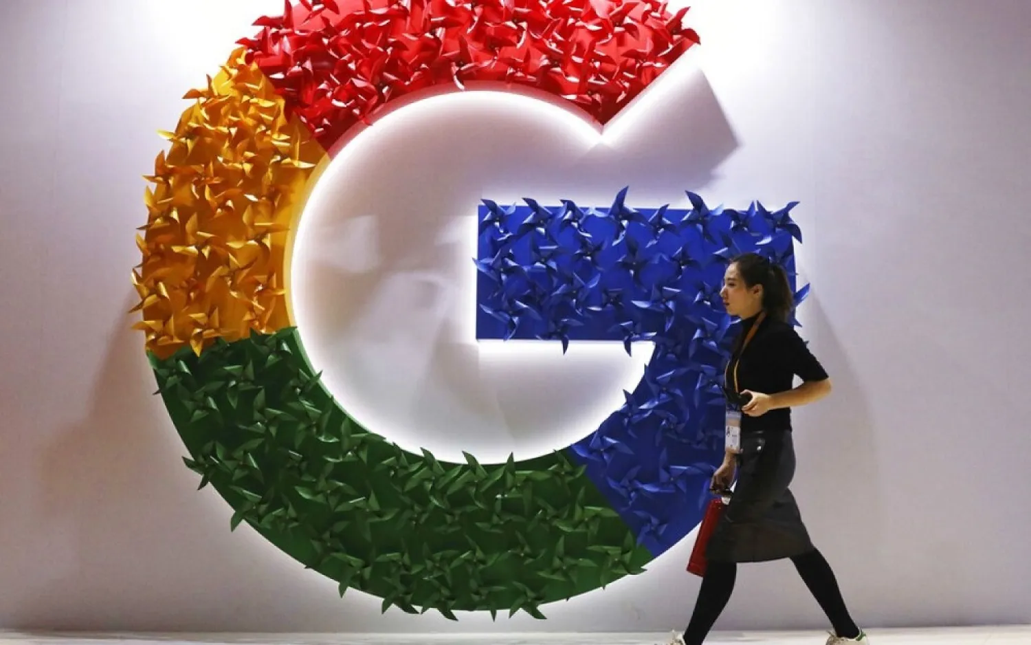 In this Monday, Nov. 5, 2018 file photo, a woman walks past the logo for Google at the China International Import Expo in Shanghai. (AP)