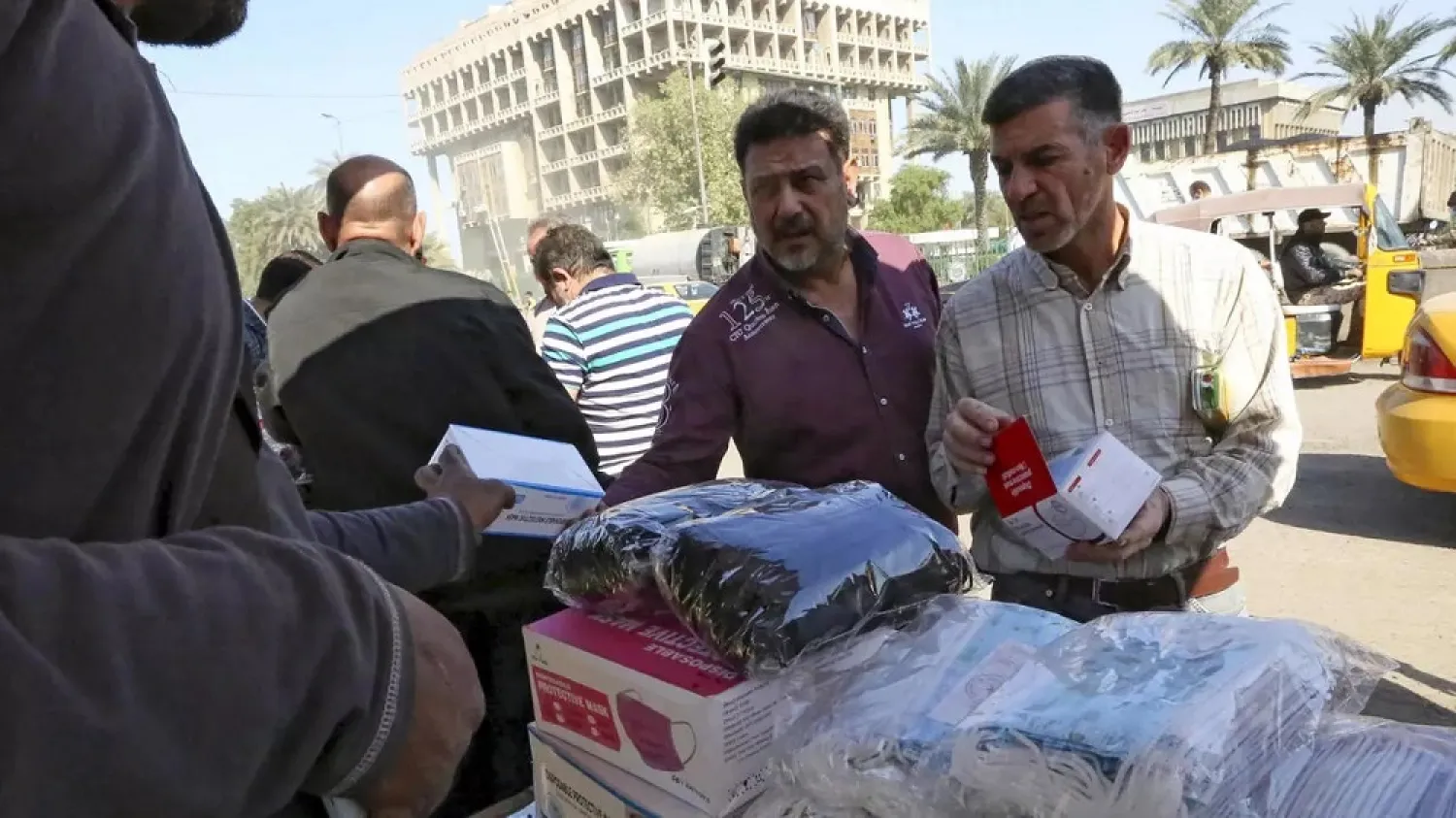 Iraqis shop for face masks in the capital Baghdad as the country faces a new surge in coronavirus infections. (AFP)