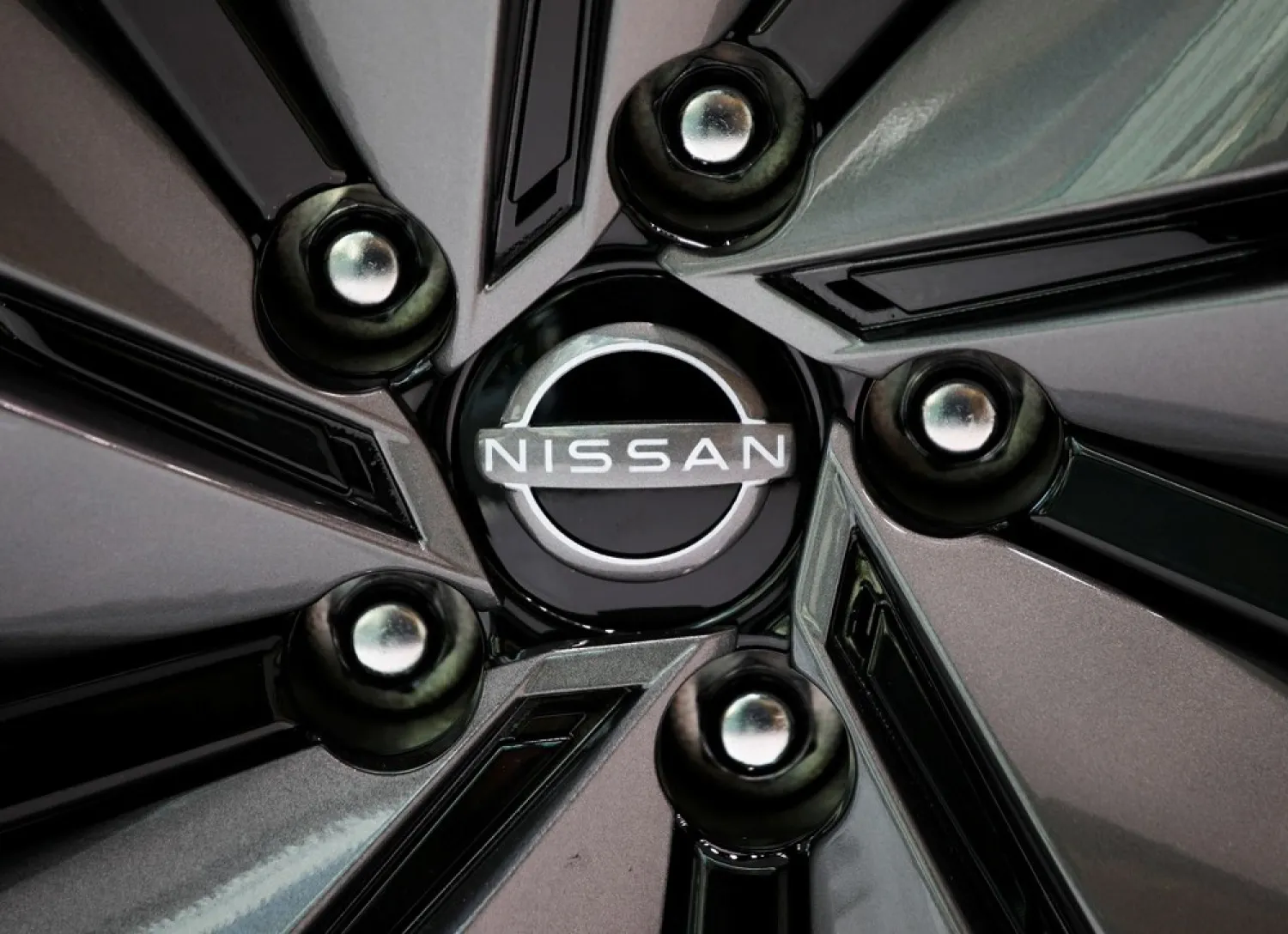 The brand logo of Nissan Motor Corp. is seen on a tire wheel of the company's car at their showroom in Tokyo, Japan November 11, 2020. (Reuters)