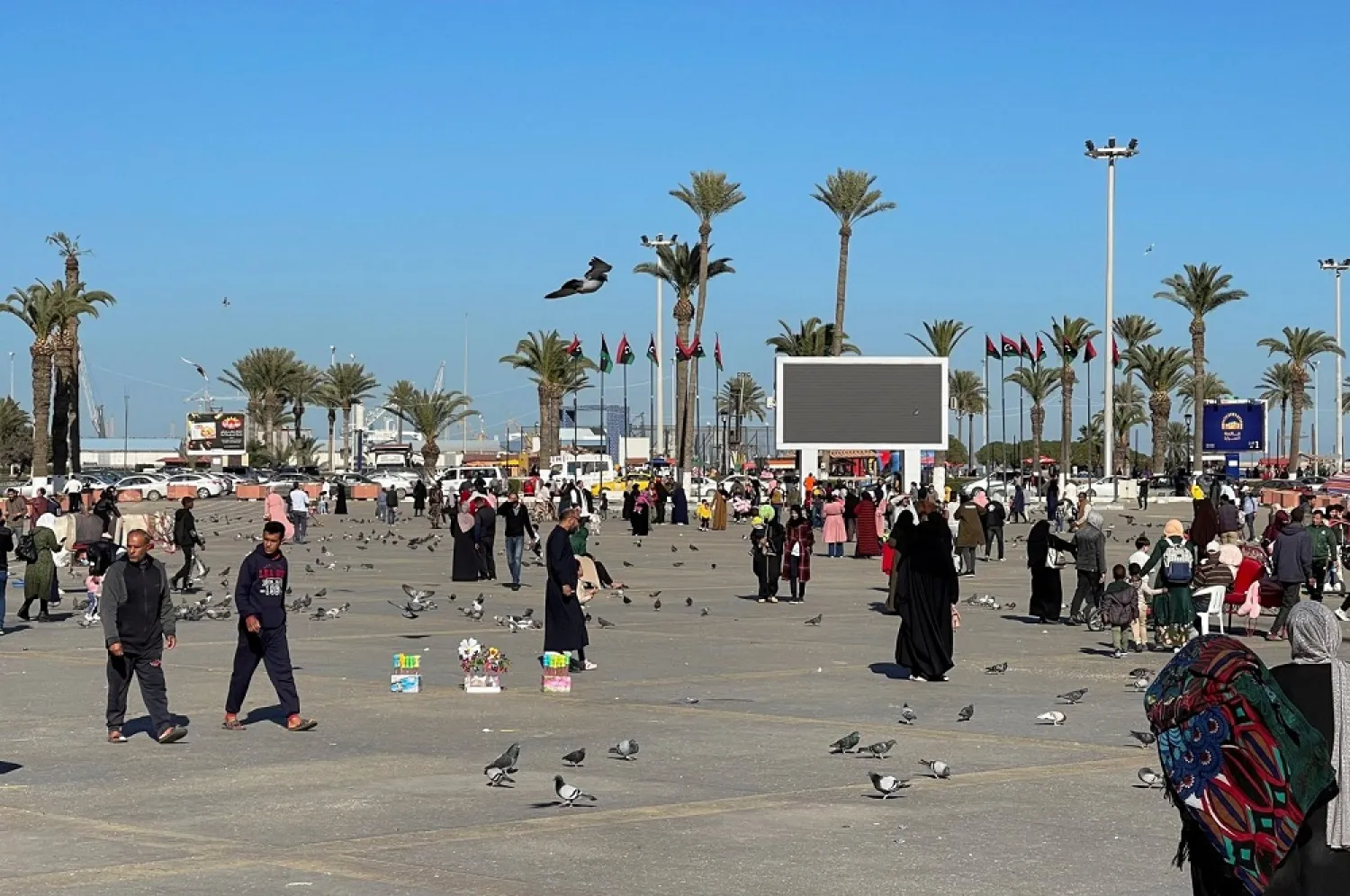 People walk at Martyrs' Square in the early hours of Friday afternoon in Tripoli, Libya, February 5, 2021. (Reuters)