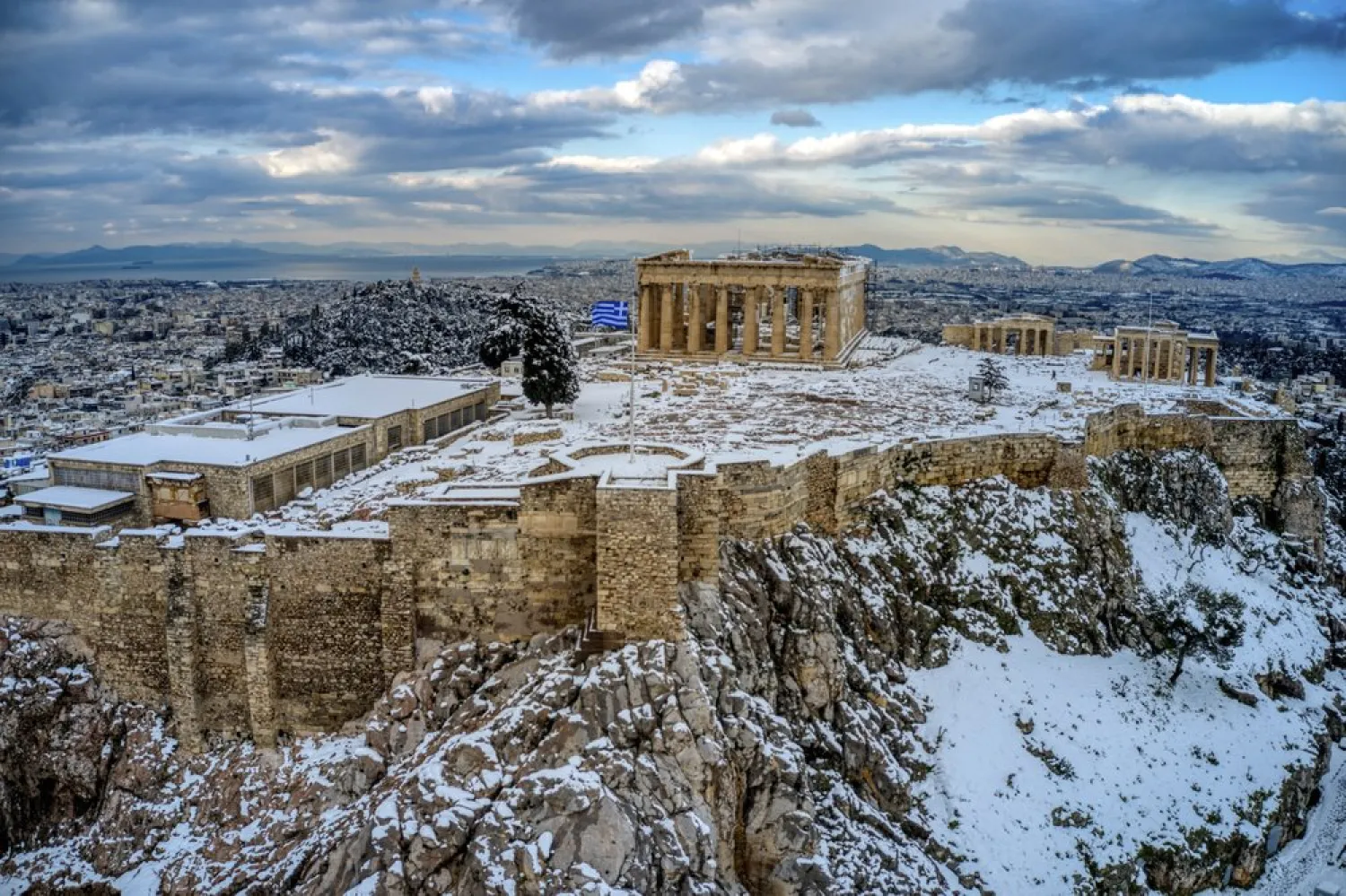The ancient Acropolis hill is covered with snow after heavy snowfall in Athens, Wednesday, Feb. 17, 2021. Greece has called in the armed forces to help cope with the damage caused heavy snowfall that has left parts of greater Athens without power and water for up to three days. (Antonis Nikolopoulos/Eurokinissi via AP)
