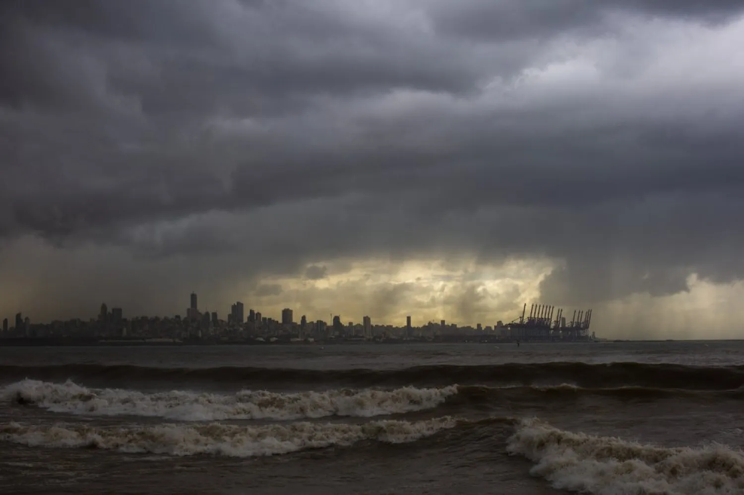 Heavy clouds hover over Beirut as waves crash on the seawall of the corniche, in Dbayeh, Lebanon, Wednesday, Feb. 17, 2021. (AP)