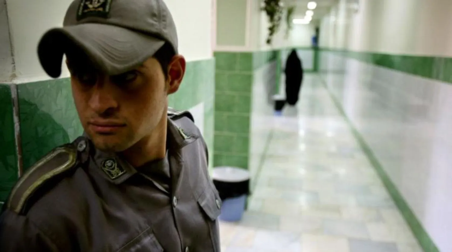A prison guard stands along a corridor in Tehran's Evin prison June 13, 2006. Reuters file photo
