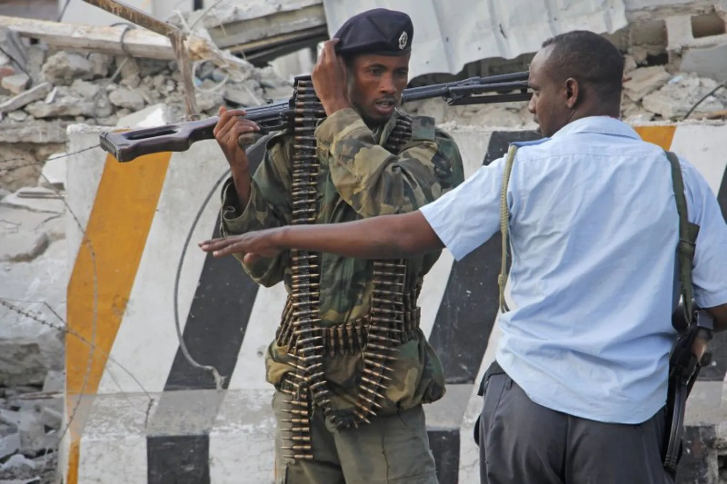 Armed soldiers talk each other in Mogadishu, Somalia, Sunday, Oct 29, 2017, after a car bomb detonated Saturday night - (AP Photo/Farah Abdi Warsameh)
