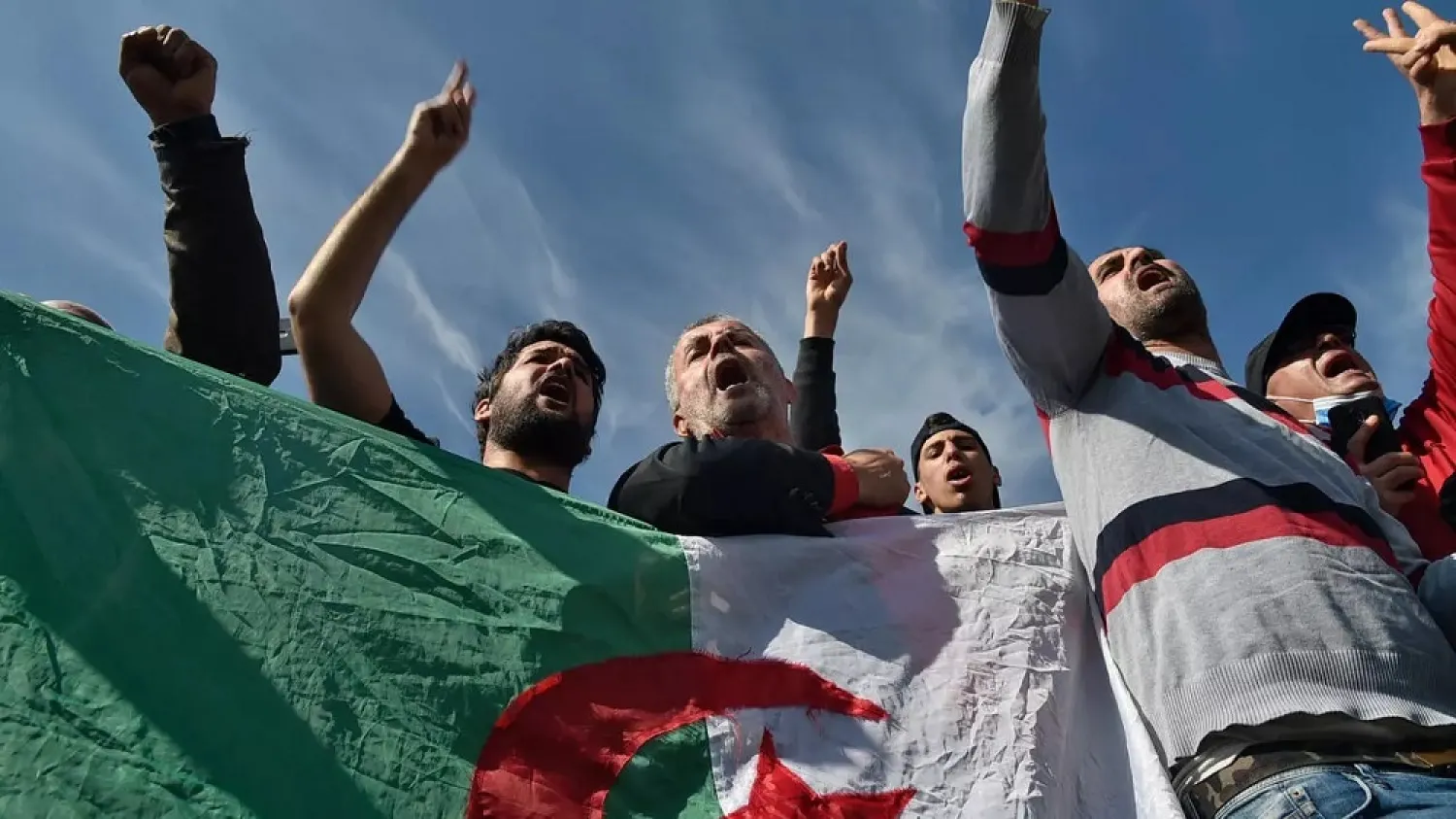 Algerians waving flags gathered outside the Kolea prison on Friday to await activists expected to be freed under a presidential pardon. (AFP)