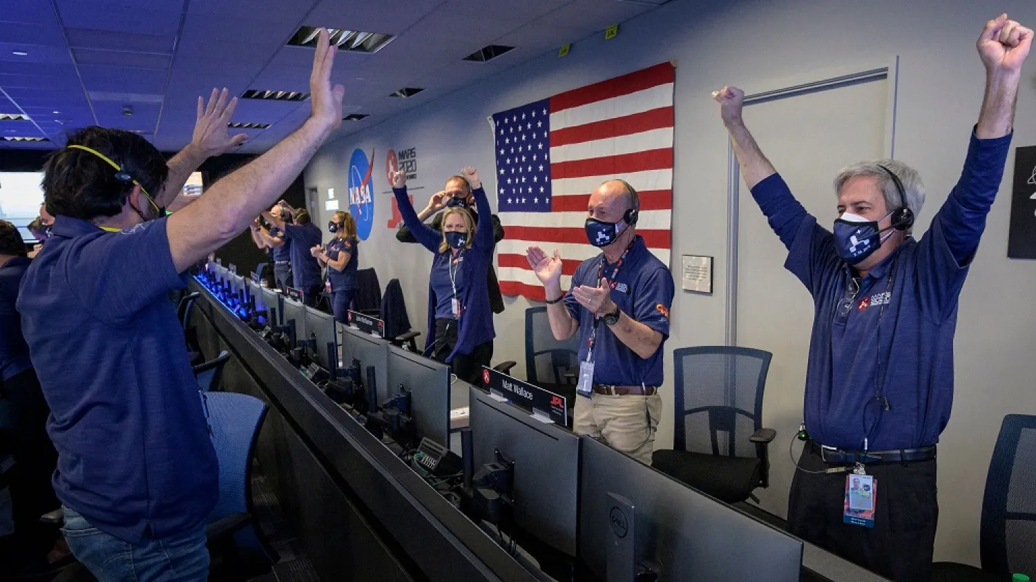 Members of NASA's Perseverance rover team react in mission control after receiving confirmation that the spacecraft successfully touched down on Mars. (AFP)