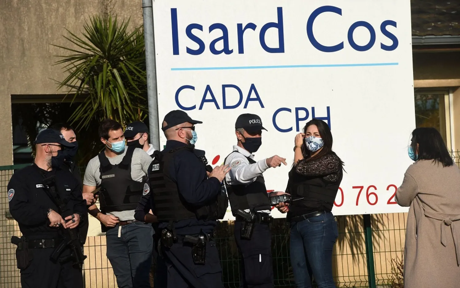 Police officers stand at the entrance of the Isard COS Reception Center for Asylum Seekers (CADA) in Pau. (AFP)