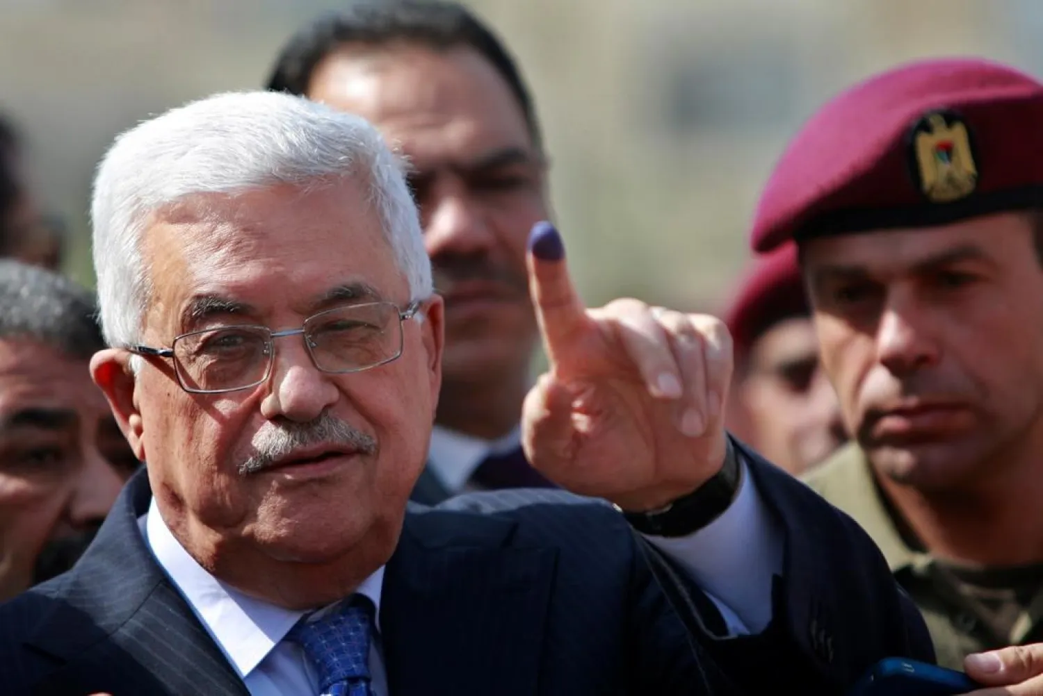 In this Oct. 20, 2012 file photo, Palestinian President Abbas shows his ink-stained finger after casting his vote during local elections at a polling station in the West Bank city of Ramallah. (AP)