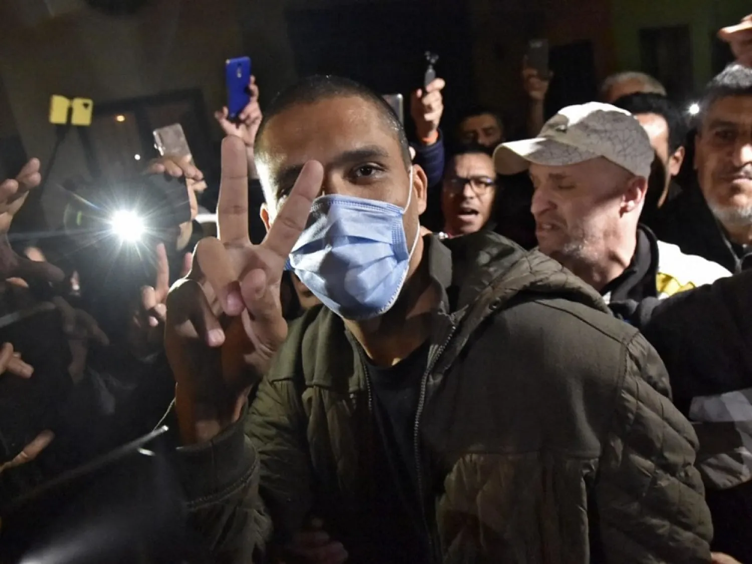 Algerian journalist Khaled Drareni greets supporters on his release from the Kolea prison, west of the capital Algiers, on February 19, 2021. (AFP)