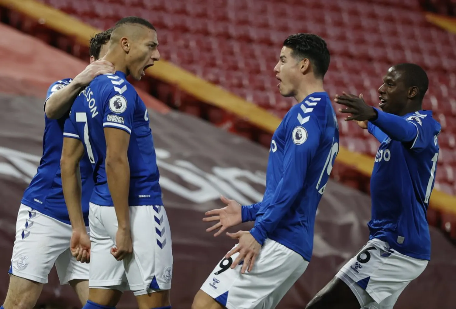 Everton's Richarlison, second left celebrates with teammates after scoring the opening goal during the Premier League match against Liverpool and Everton at Anfield in Liverpool, England, Feb. 20, 2021. (AP)