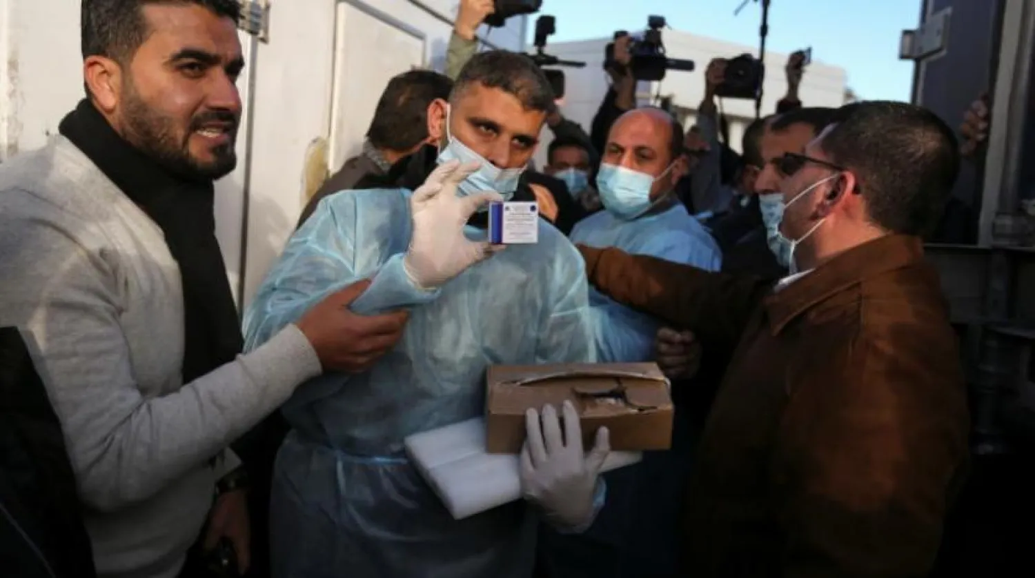 A Palestinian health worker shows a box of Russia's Sputnik V vaccine sent by United Arab Emirates, amid the coronavirus disease (COVID-19) outbreak, at Rafah crossing in the southern Gaza Strip February 21, 2021. REUTERS/Ibraheem Abu Mustafa