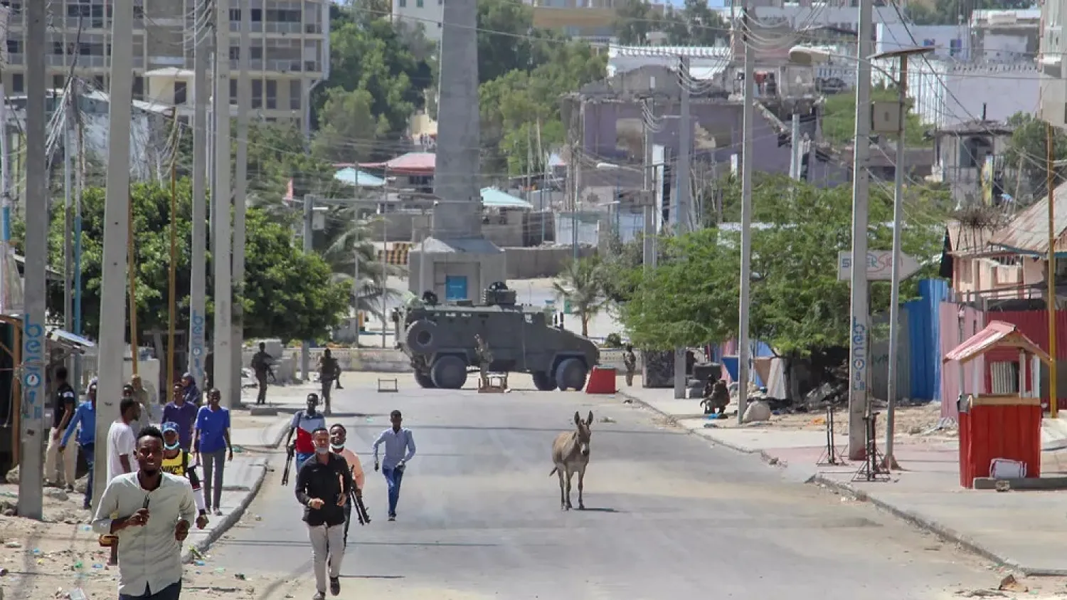 Men flee the site of the violent clashes in the Somali capital. (Reuters)
