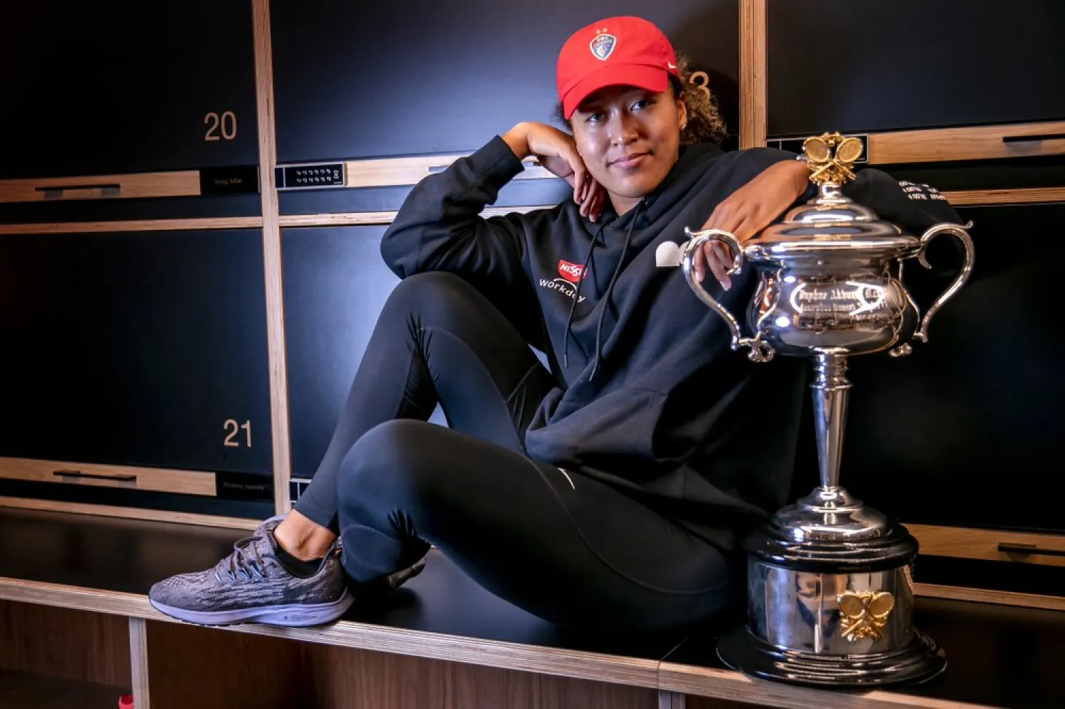 Naomi Osaka with the cup in the locker room in the early hours of Sunday Feb. 21, 2021 after defeating Jennifer Brady in the final at the Australian Open. (Tennis Australia via AP)
