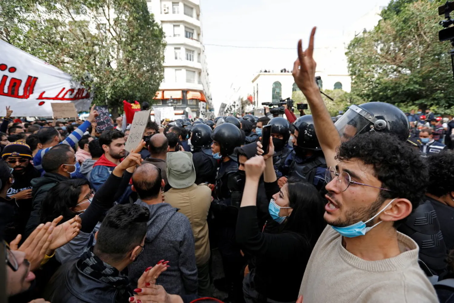 Demonstrators attend a protest to mark the anniversary of a prominent activist's death and against allegations of police abuse, in Tunis, Tunisia February 6, 2021. (Reuters)