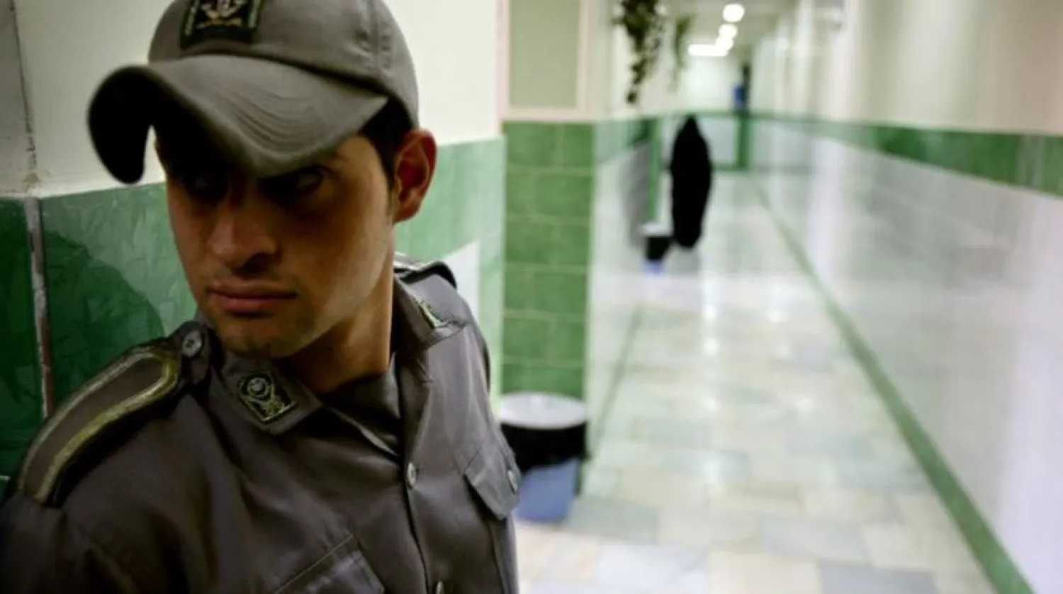 A prison guard stands along a corridor in Tehran's Evin prison June 13, 2006. Reuters file photo
