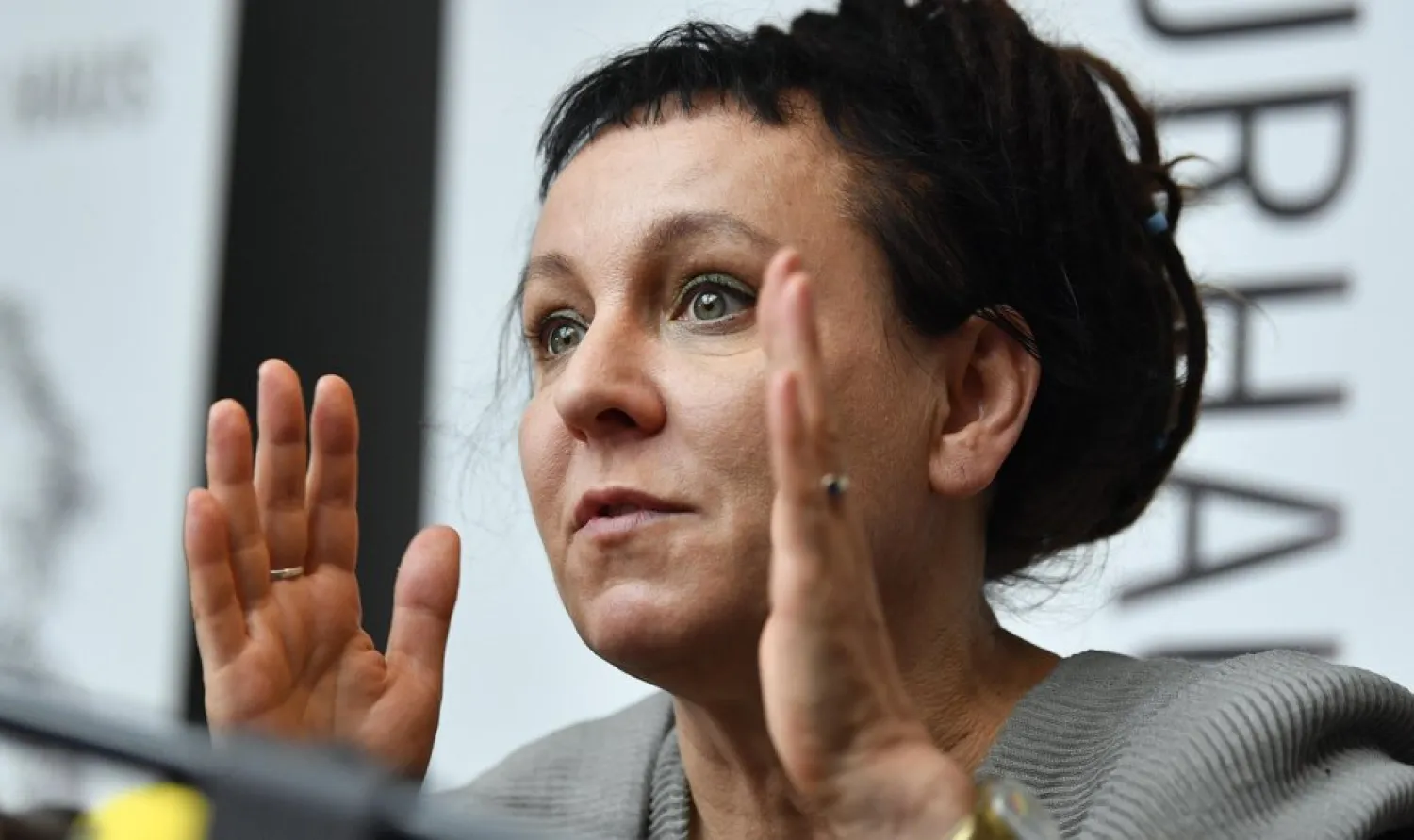 In this Friday, Oct. 11, 2019 file photo, Polish writer and Nobel Prize winner Olga Tokarczuk reacts to the media during a press conference in Duesseldorf, Germany. (AP Photo/Martin Meissner, File)