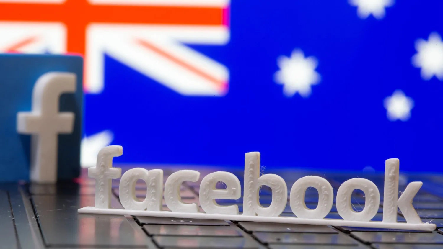 A 3D printed Facebook logo is seen in front of displayed Australia’s flag in this illustration photo taken February 18, 2021. REUTERS/Dado Ruvic/Illustration