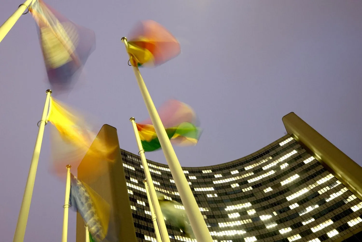 Flags flutter in the wind in front of the headquarters of the International Atomic Energy Agency (IAEA) in Vienna, Austria, December 16, 2020. (Reuters)