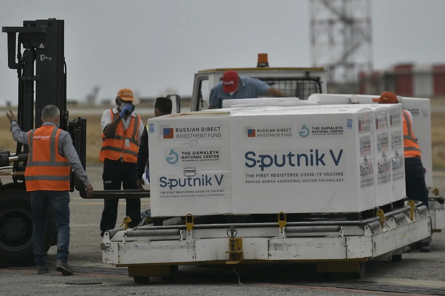 Illustrative: Workers unload a shipment of the Russian COVID-19 vaccine Sputnik V, at the Simon Bolivar International Airport in Maiquetia, Venezuela, Saturday, Feb. 13, 2021. (AP)
