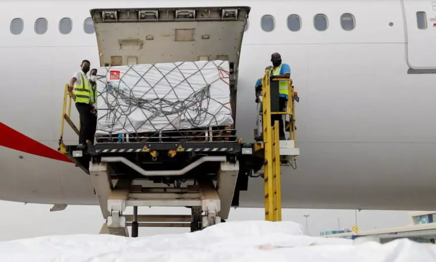 Workers offload boxes of Oxford-AstraZeneca vaccines as the country receives its first batch of COVID-19 jabs under the COVAX scheme, at the international airport of Accra, Ghana February 24, 2021. Reuters