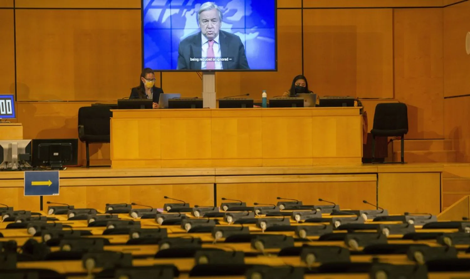 A screen shows UN Secretary-General Antonio Guterres making his statement by video, during the opening of the 46th session of the Human Rights Council, at the European headquarters of the United Nations in Geneva, Switzerland, Monday Feb. 22, 2021. (Salvatore Di Nolfi/Keystone via AP)