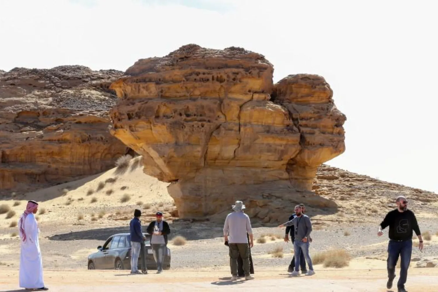 Visitors tour near Rock formations that resemble human face at the Madain Saleh antiquities site in Al-Ula, Saudi Arabia. Reuters file photo