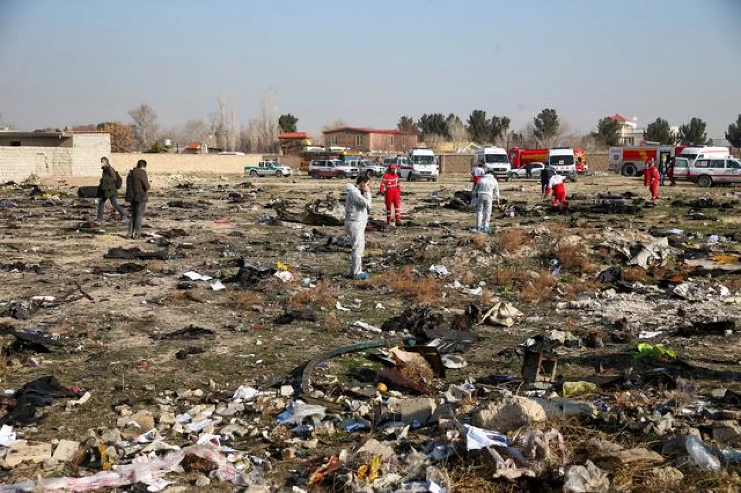 FILE PHOTO: Rescue team works among debris of a plane belonging to Ukraine International Airlines, that crashed after take-off from Iran's Imam Khomeini airport, on the outskirts of Tehran, Iran January 8, 2020. Nazanin Tabatabaee/WANA (West Asia News Agency) via REUTERS