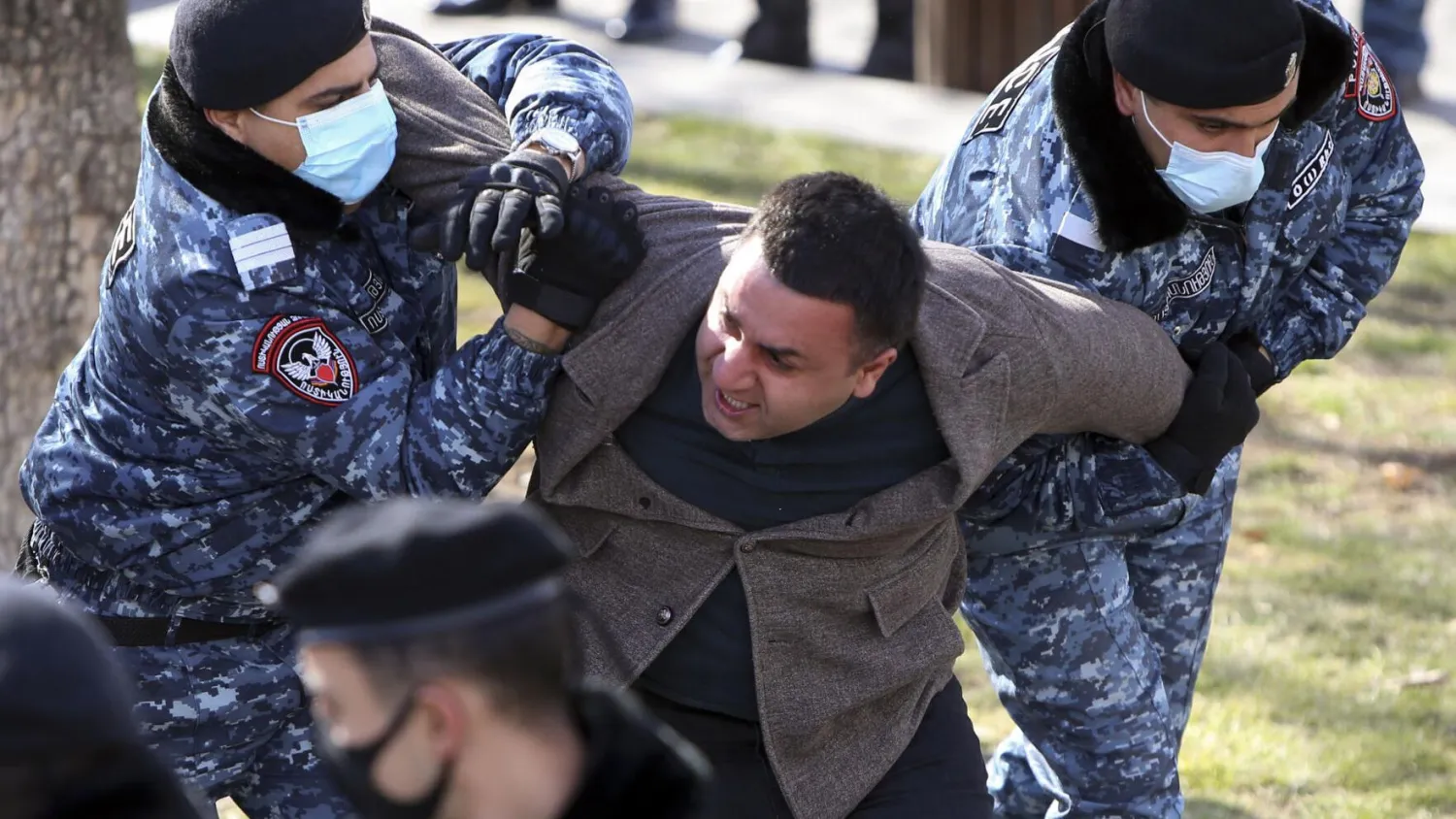 Police detain an opposition demonstrator during an anti-government protest at the government building in Yerevan, Armenia, Tuesday, Feb. 23, 2021. 