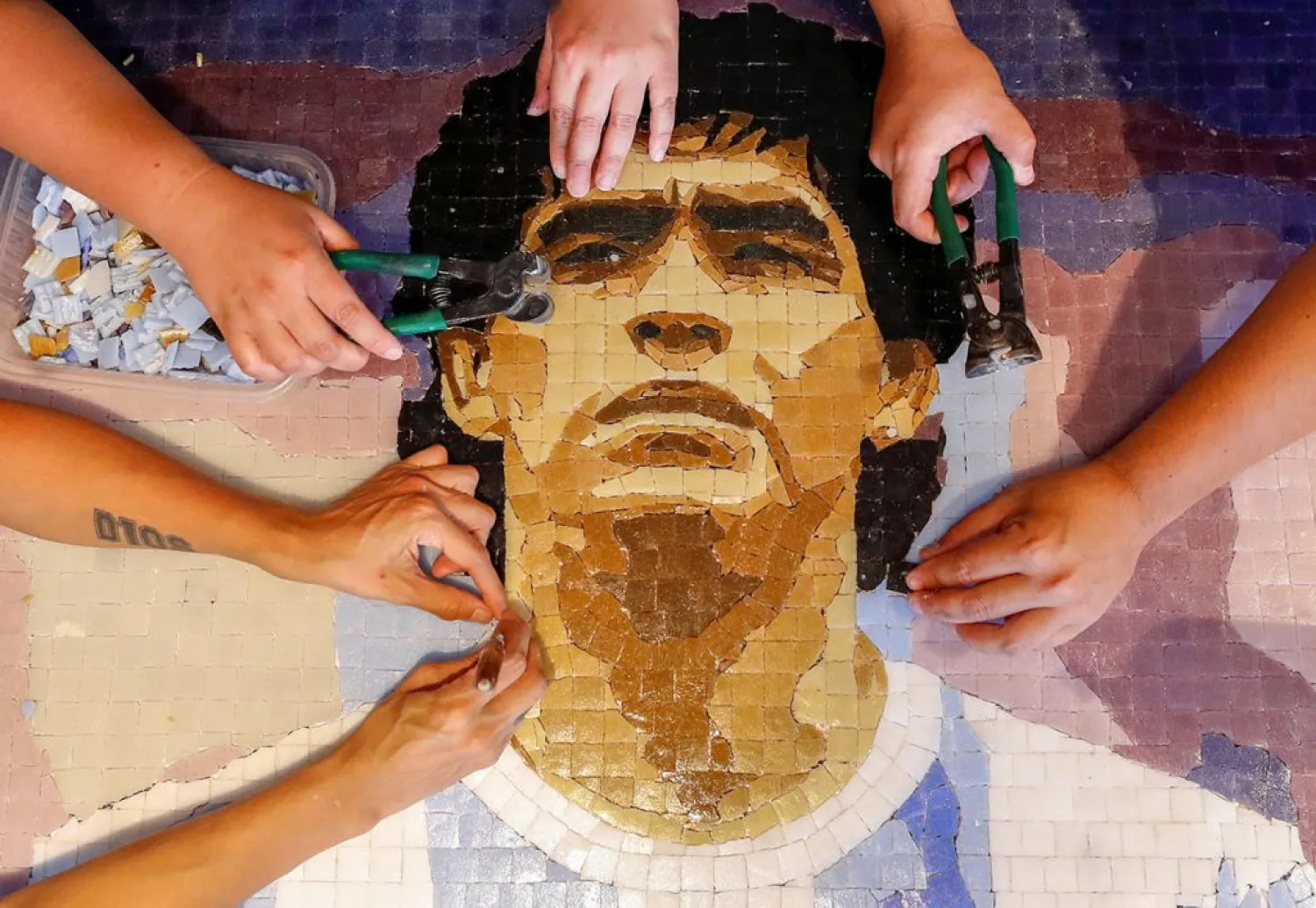 Gonzalo Lopez Lauch, part of a group called Comando Maradona, prepares a mosaic as a homage to late superstar Diego Armando Maradona, at their workshop, in Buenos Aires. (Reuters)