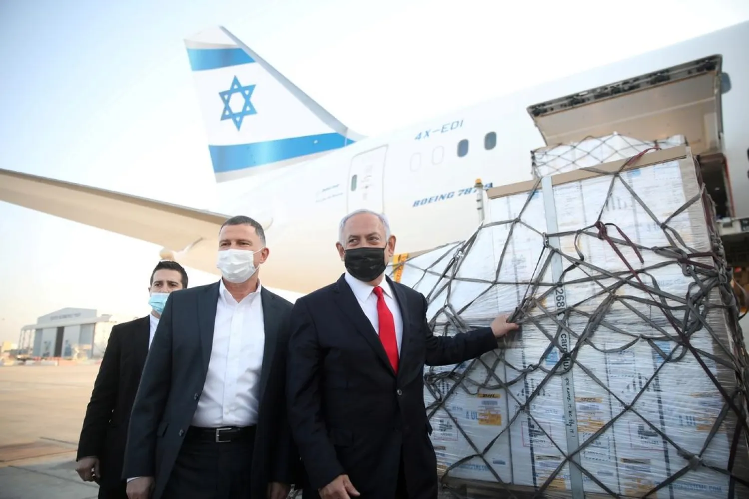 Israel PM Netanyahu and Health Minister Yuli Edelstein attend the arrival of a plane with a shipment of Pfizer-BioNTech coronavirus vaccines, at Ben Gurion airport, Israel, January 10, 2021. (Reuters)