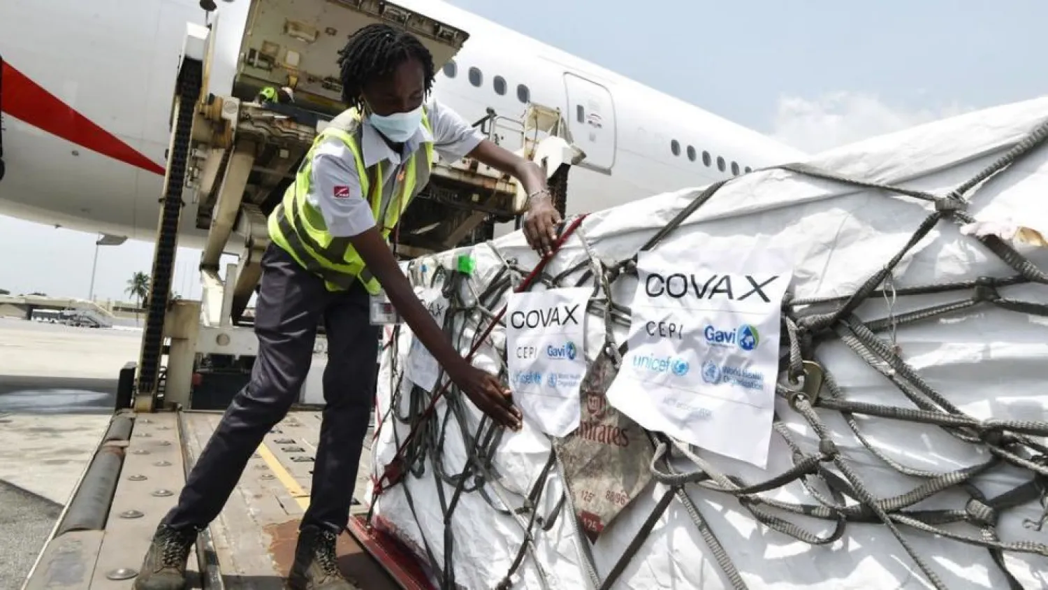 Workers unload a shipment of AstraZeneca Covid-19 vaccines from a plane in the Ivory Coast | AFP